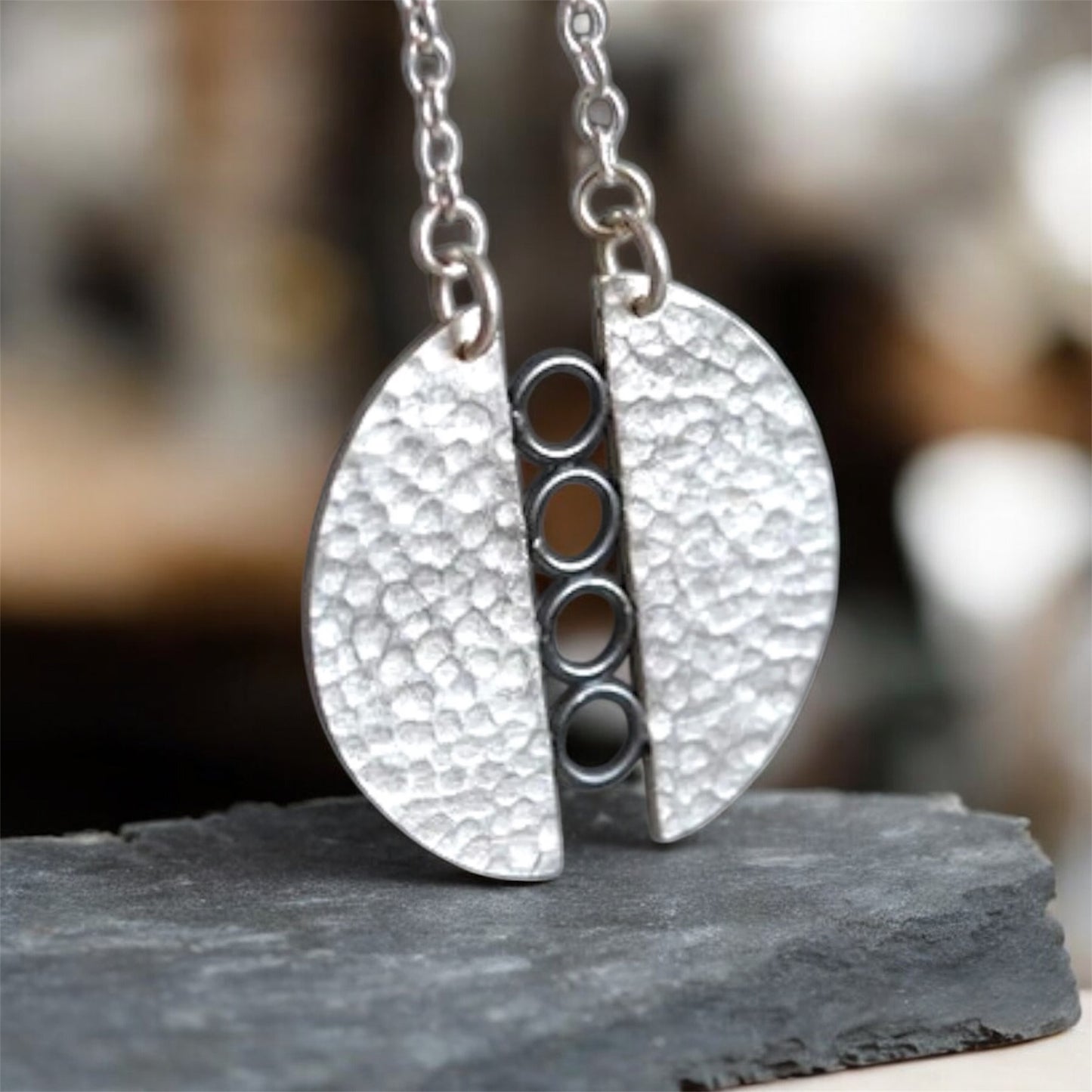 Sterling silver textured circle pendant necklace.