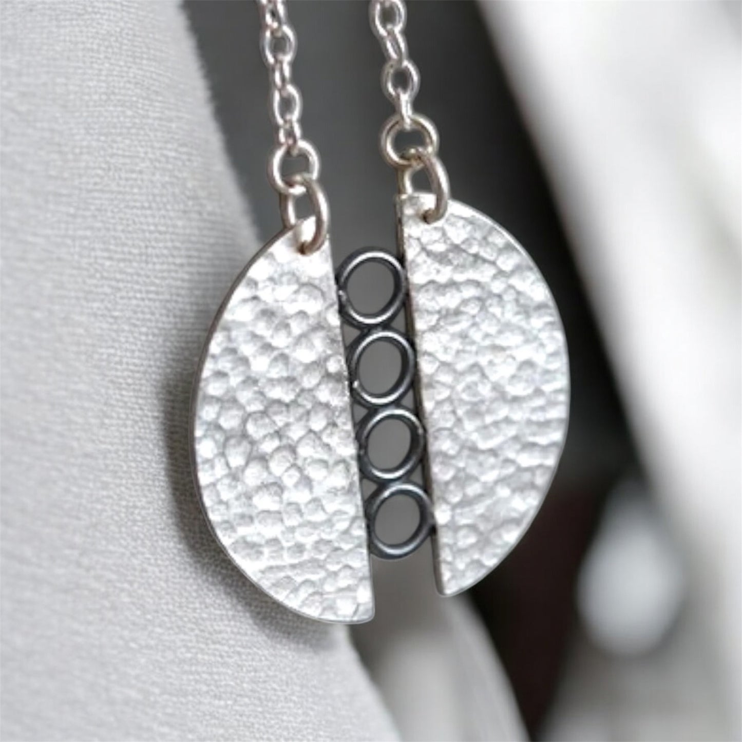 Sterling silver textured circle pendant necklace.