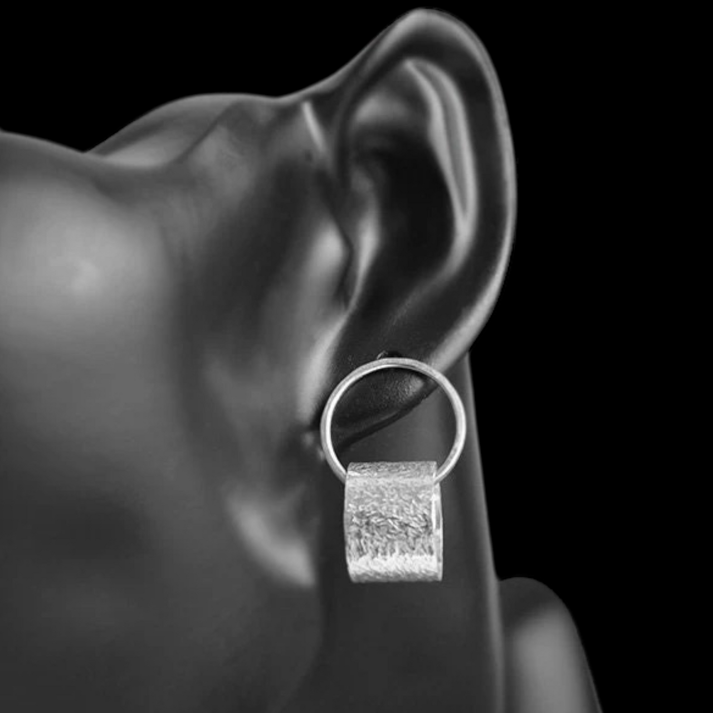 Sterling silver circle stud earrings.