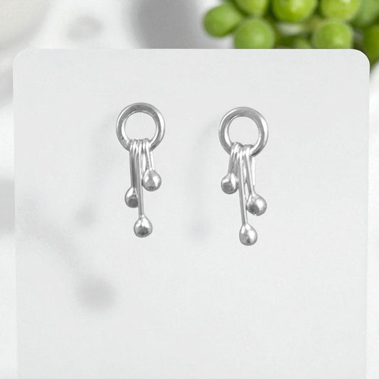 Sterling silver circle and droplets stud earrings.