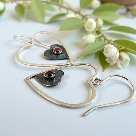 Sterling silver garnet heart earrings.