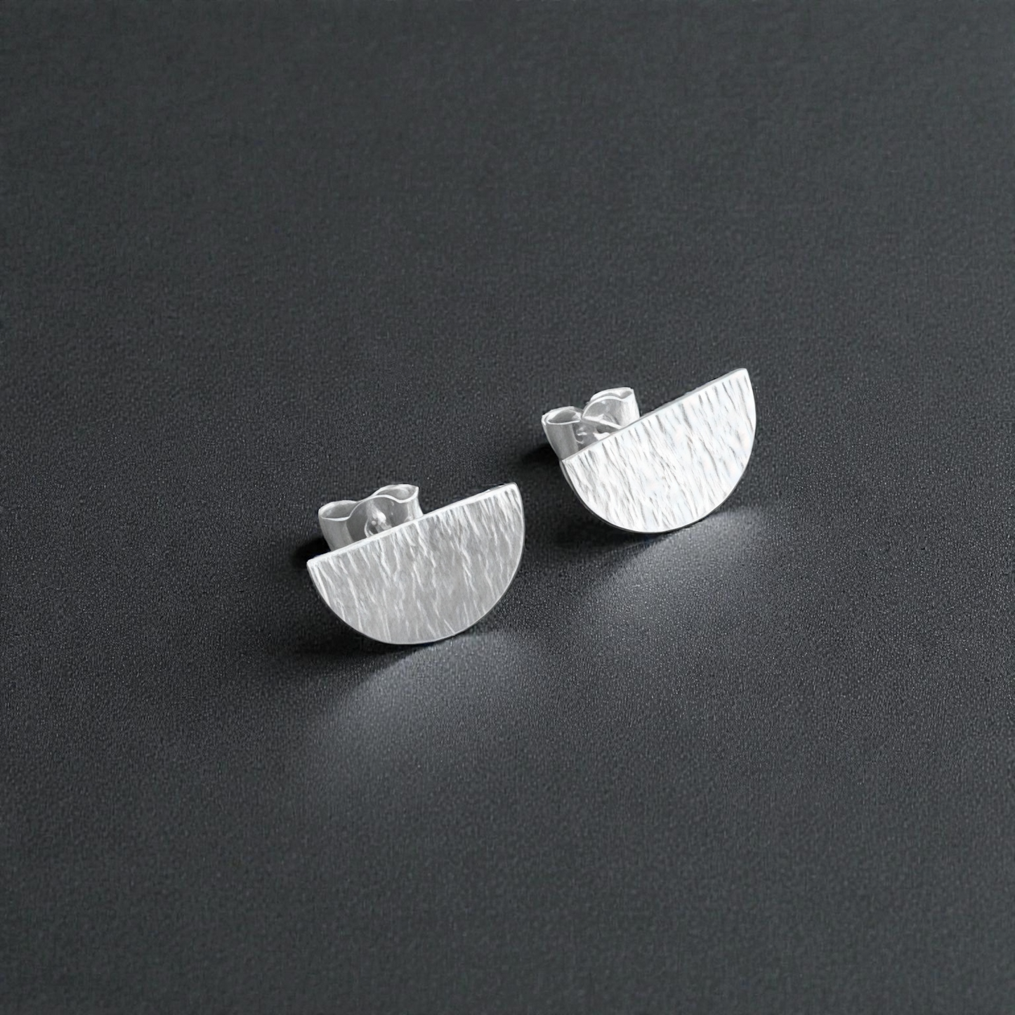 Hammered semicircle sterling silver stud earrings.