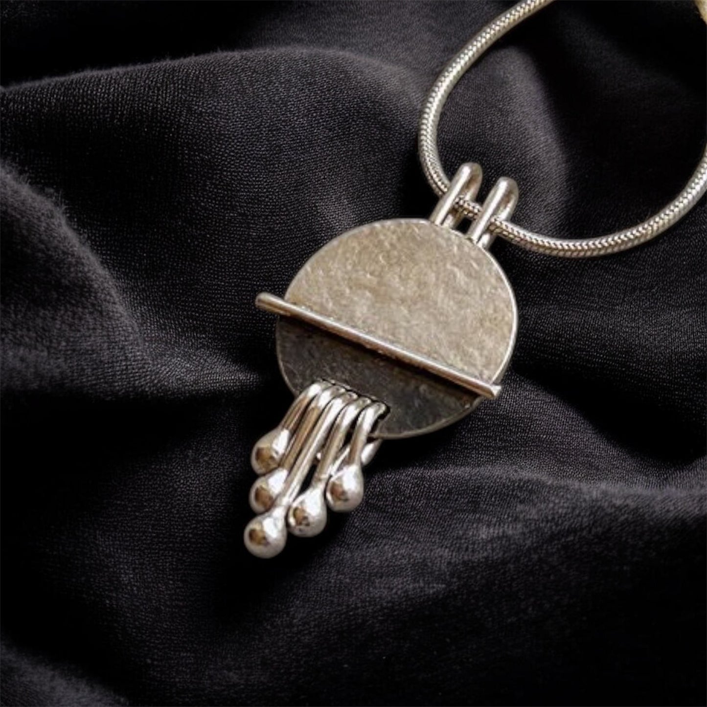 Sterling silver disc textured necklace pendant.