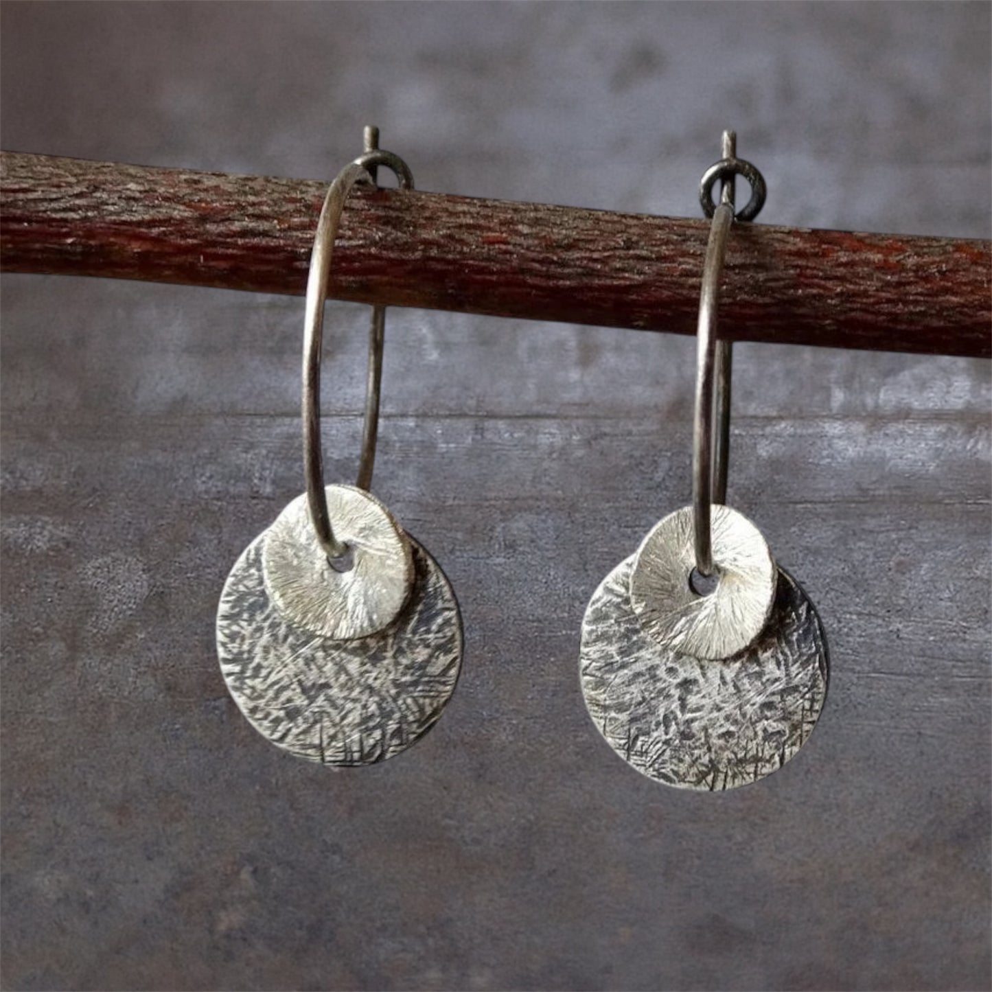 Sterling silver oxidised hammered disc hoop earrings.