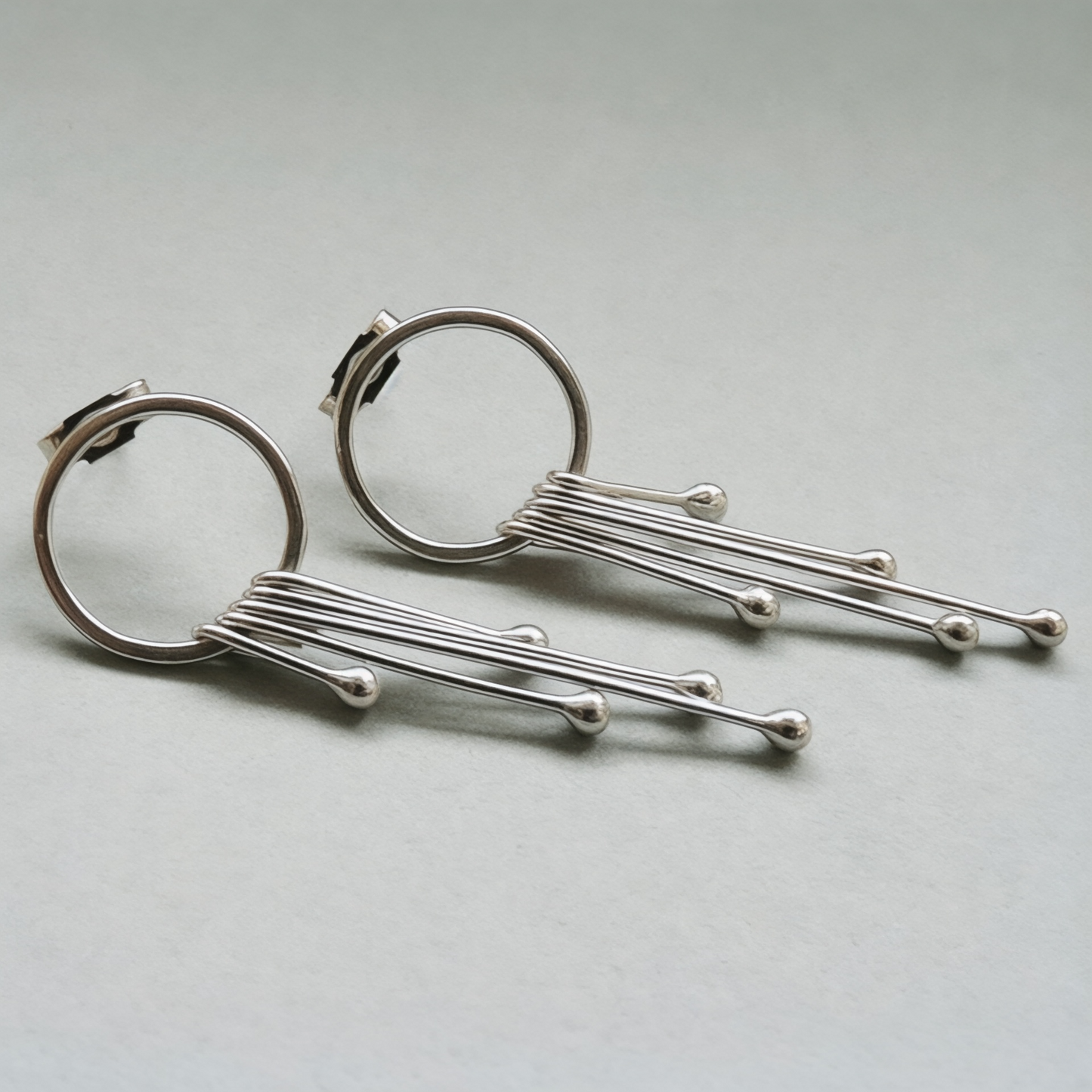 Long sterling silver circle stud earrings.