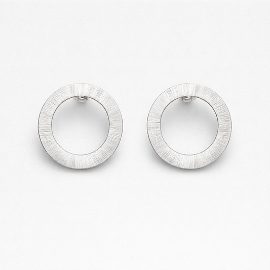 Large sterling silver circle stud earrings.