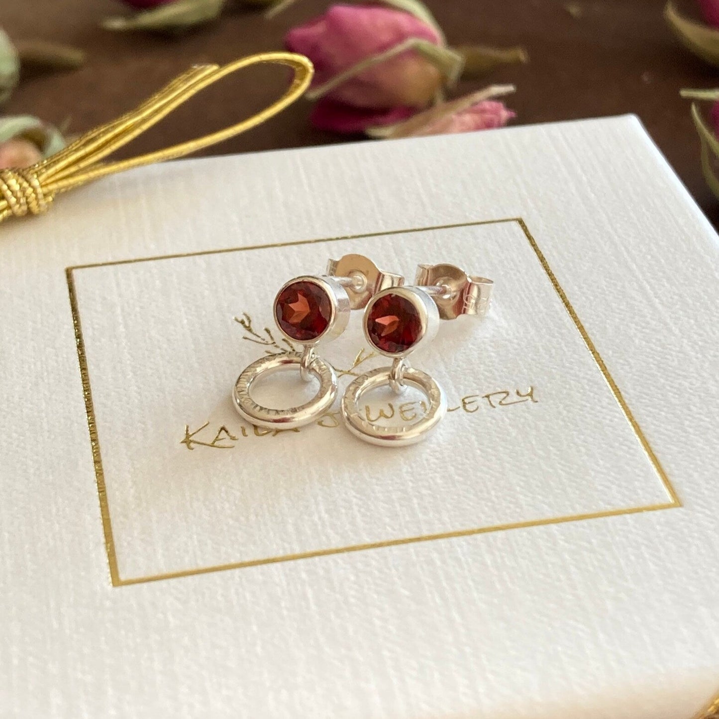 garnet sterling silver stud earrings with a small circle