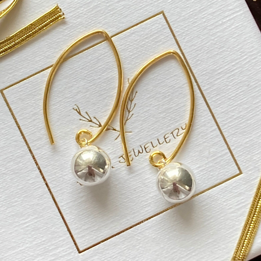Silver and gold ball dangle earrings.