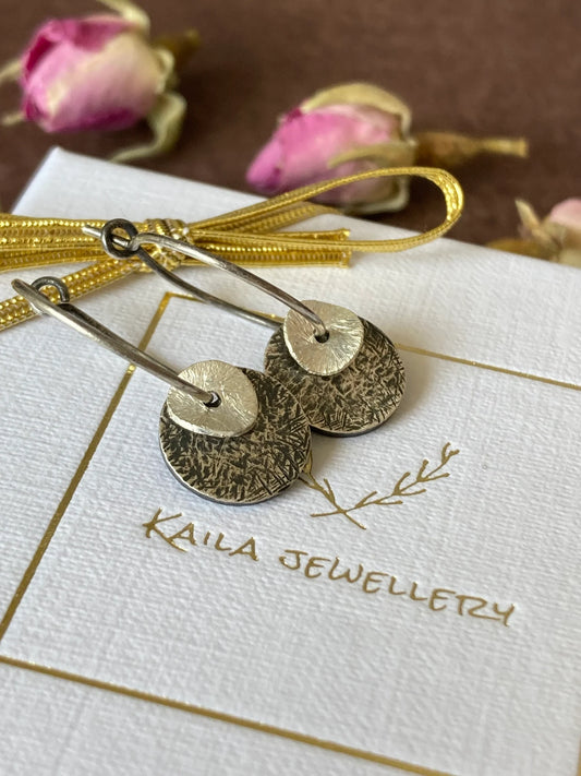 Sterling silver oxidised hammered disc hoop earrings.