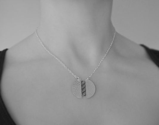 Sterling silver textured circle pendant necklace.
