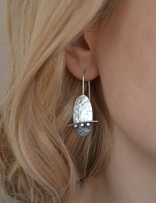 Artisan oval sterling silver drop earrings.