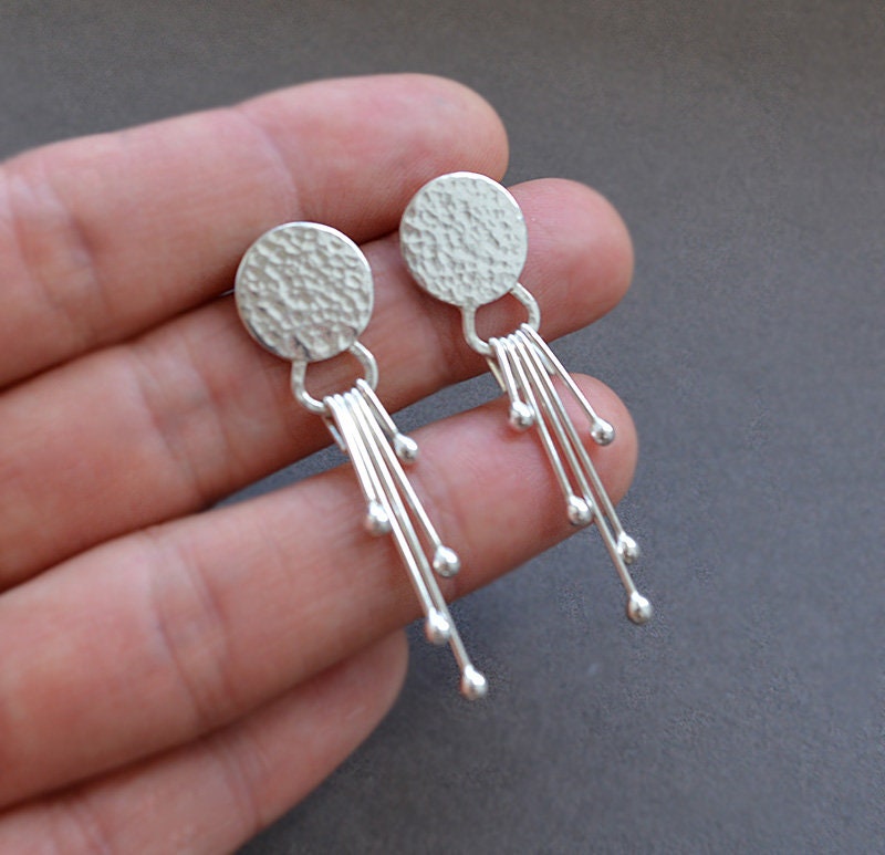 Sterling silver dangle textured disc earrings.