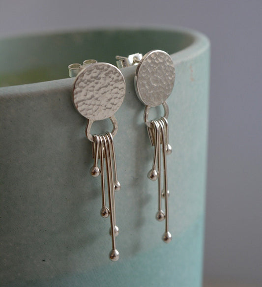 Sterling silver dangle textured disc earrings.