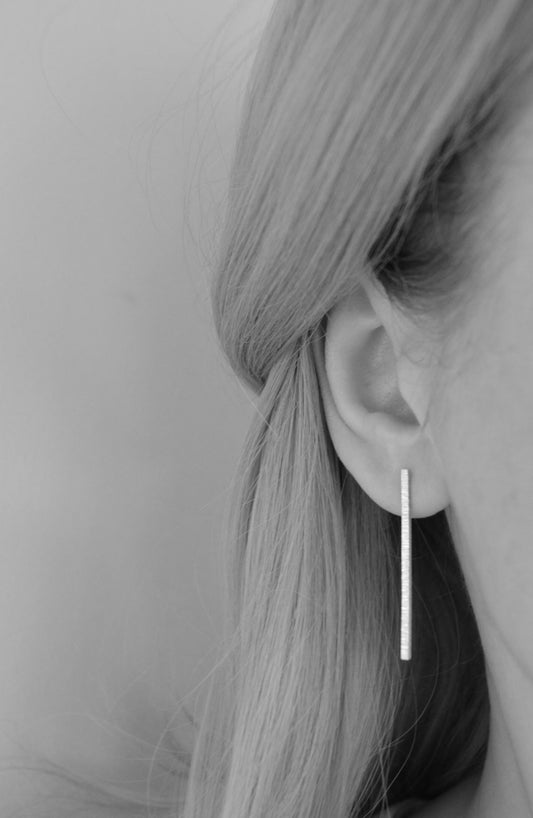 Hammered sterling silver bar stud earrings.