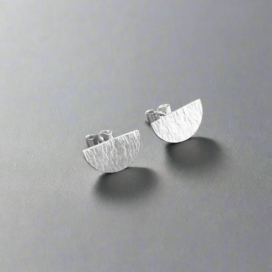 Hammered semicircle sterling silver stud earrings.