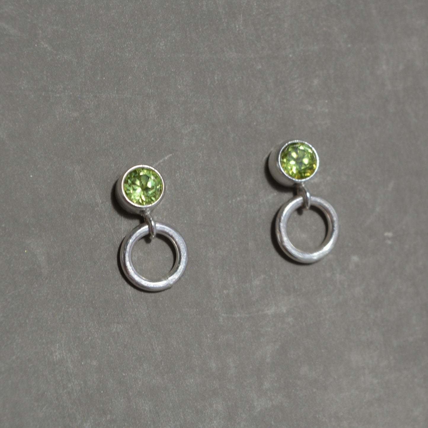 Peridot and circle sterling silver stud earrings.