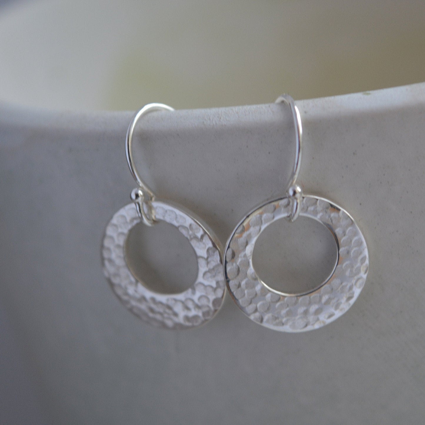 Hammered circle sterling silver earrings.