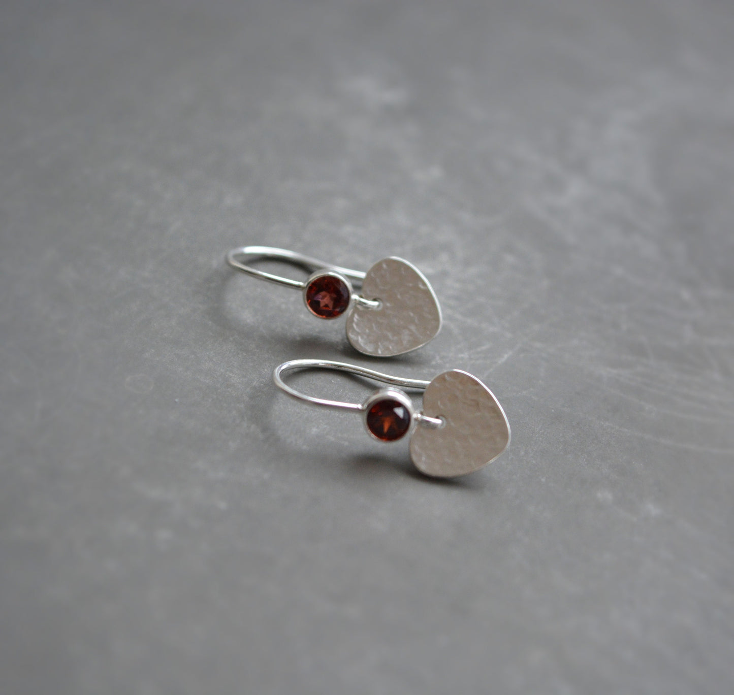 Garnet sterling silver heart dangle earrings.