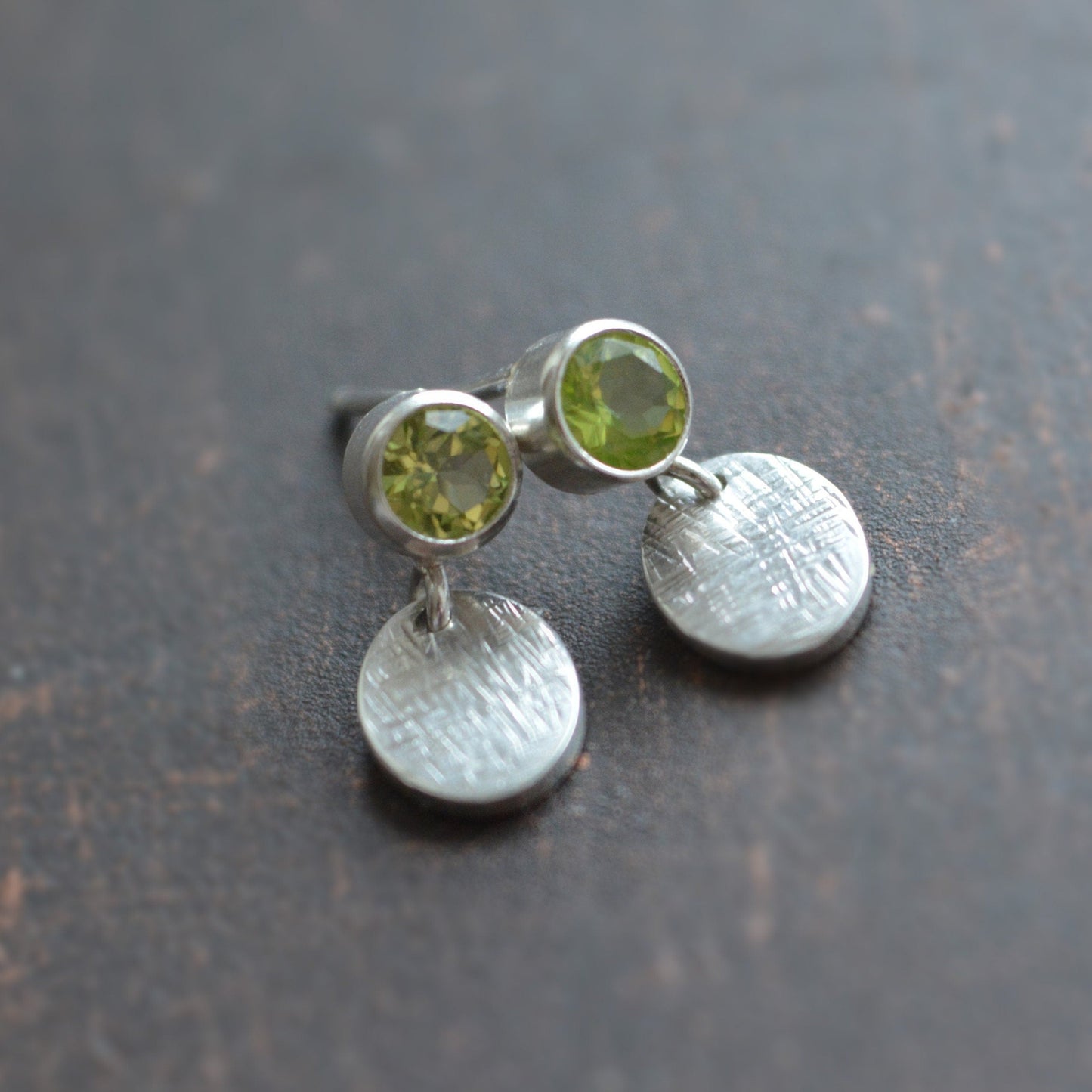 sterling silver peridot stud earrings with dangle ovals.