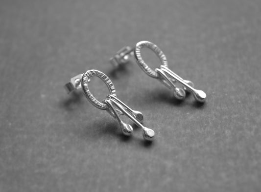 Dangle sterling silver oval stud earrings.