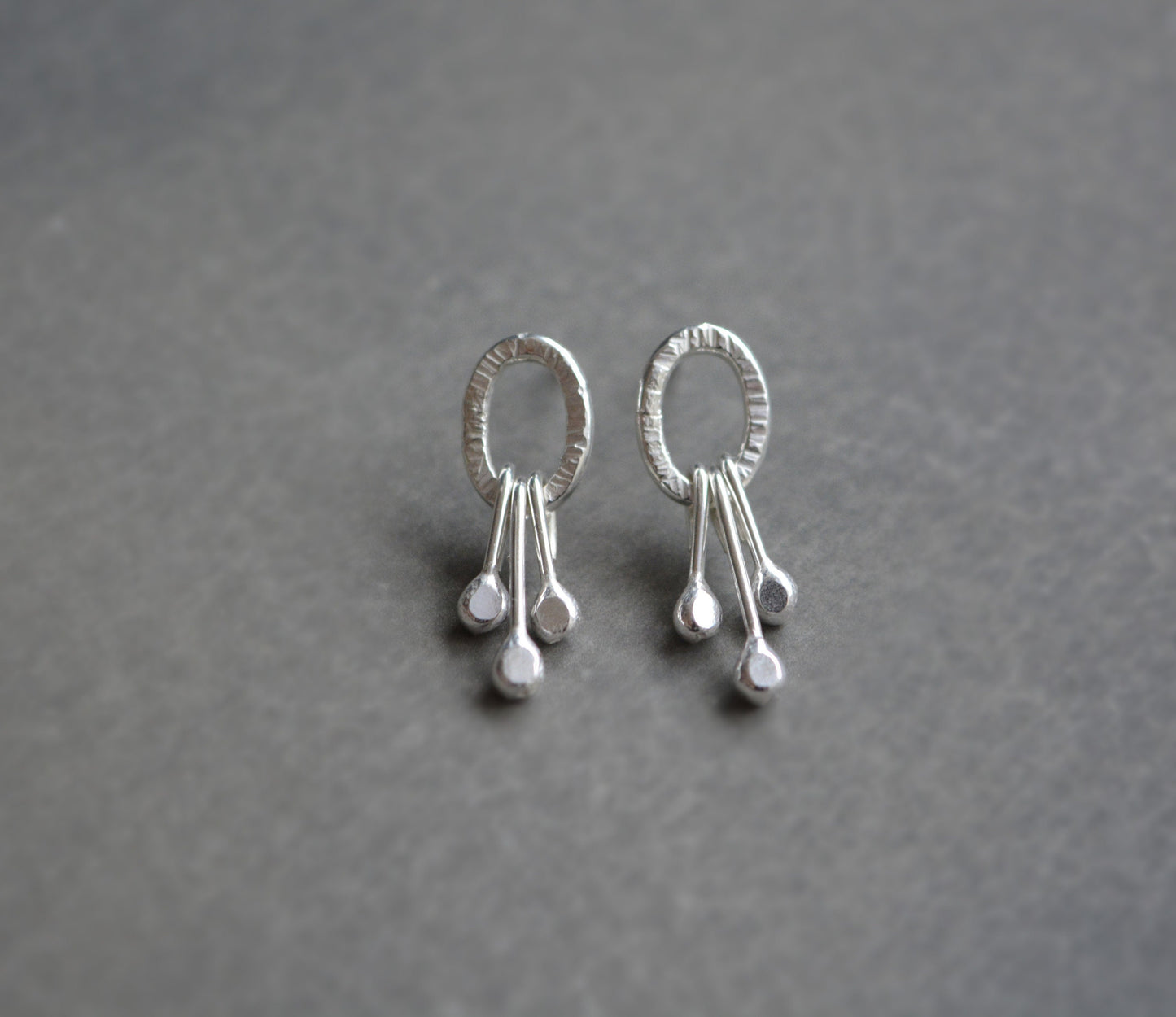 Dangle sterling silver oval stud earrings.