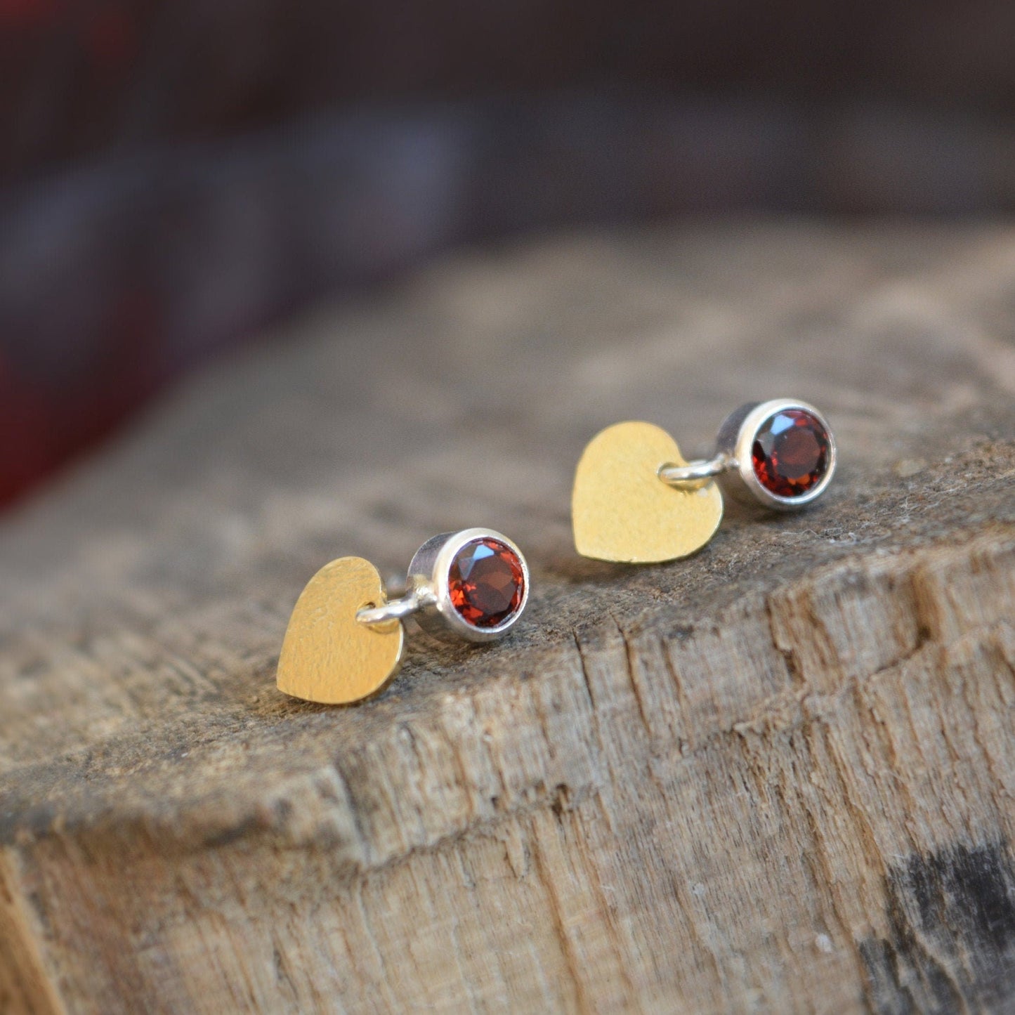 sterling silver garnet stud earrings with gold plated heart