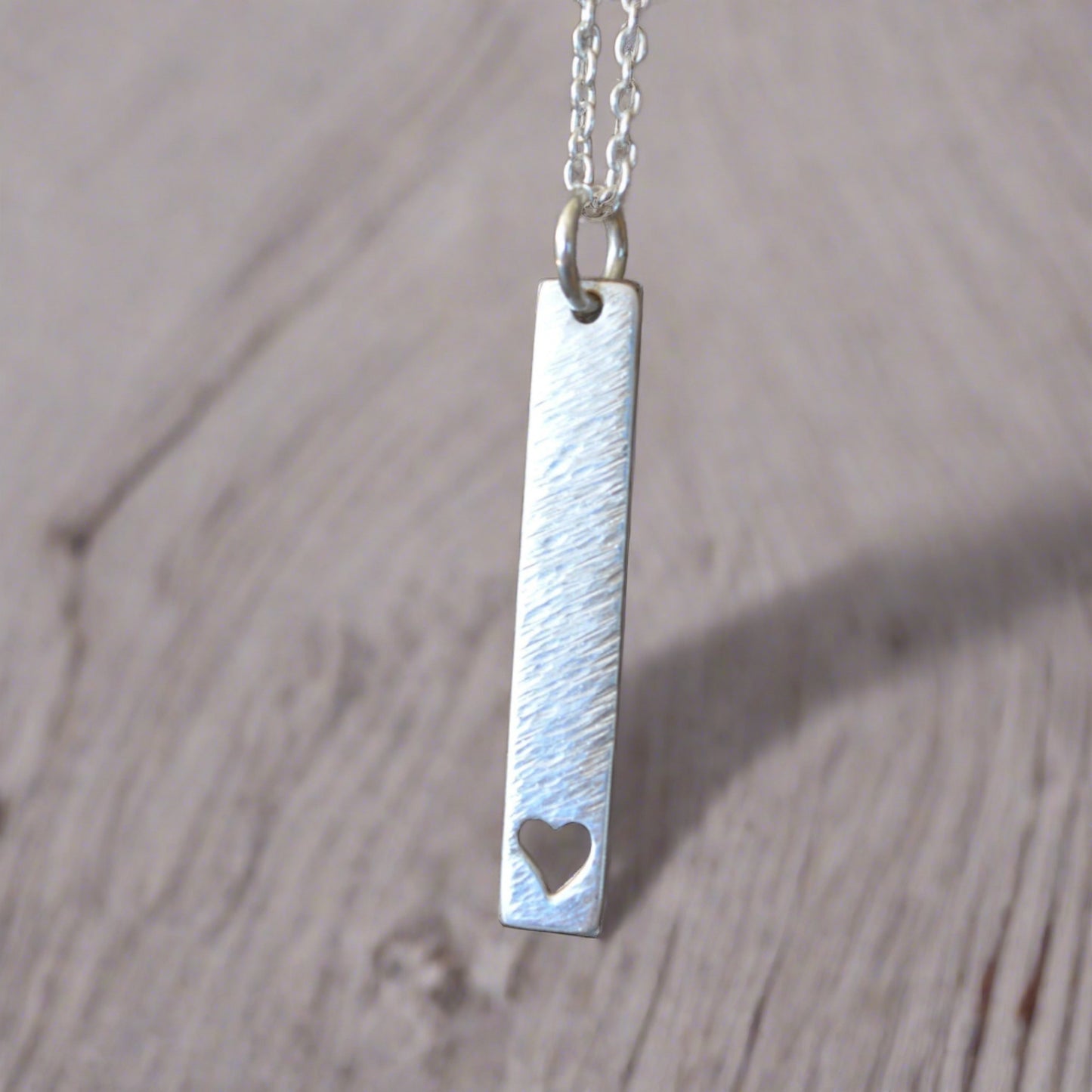 Hammered sterling silver rectangular necklace with a heart