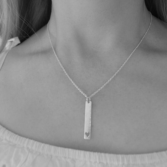 Sterling silver hammered rectangular necklace with a heart