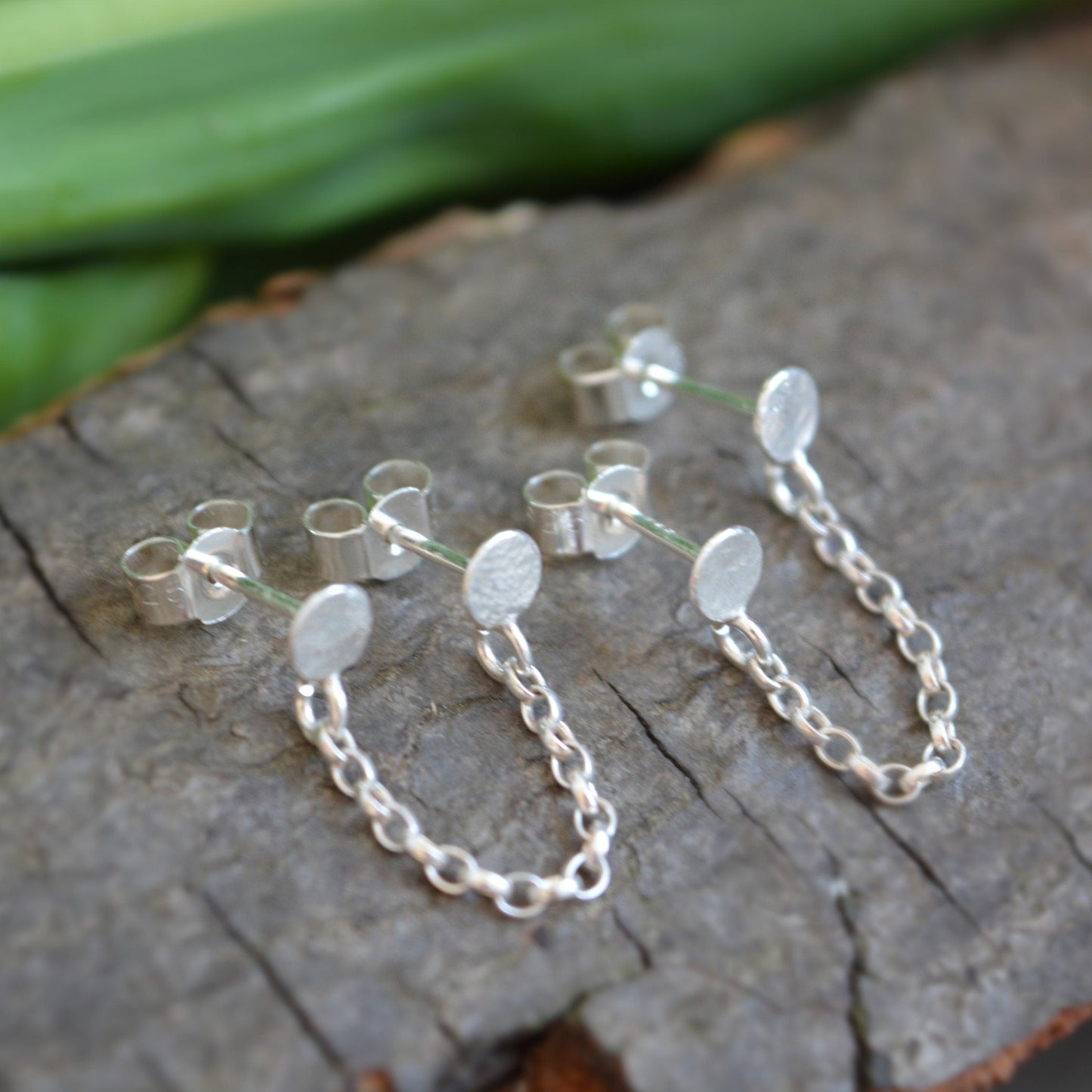 Double pierced chain sterling silver stud earrings.