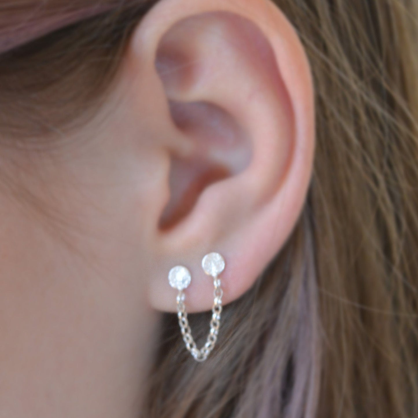 Double pierced chain sterling silver stud earrings.