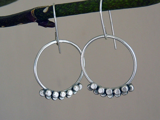 Sterling silver granulated circle dangle earrings.