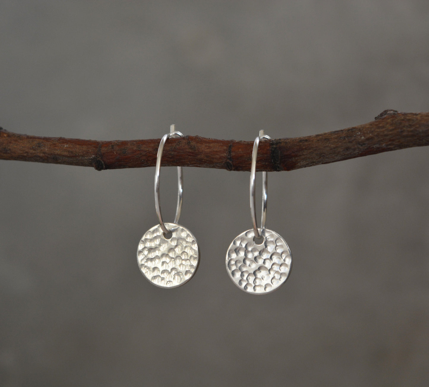 Sterling silver disc charm hoop earrings.