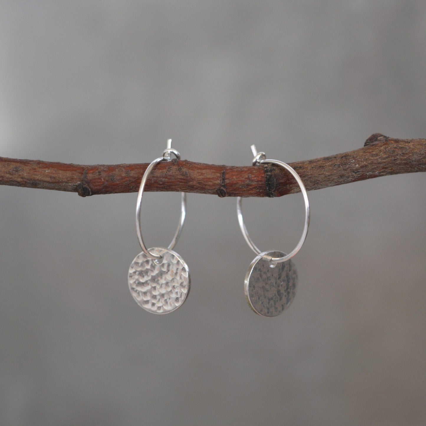 Sterling silver disc charm hoop earrings.