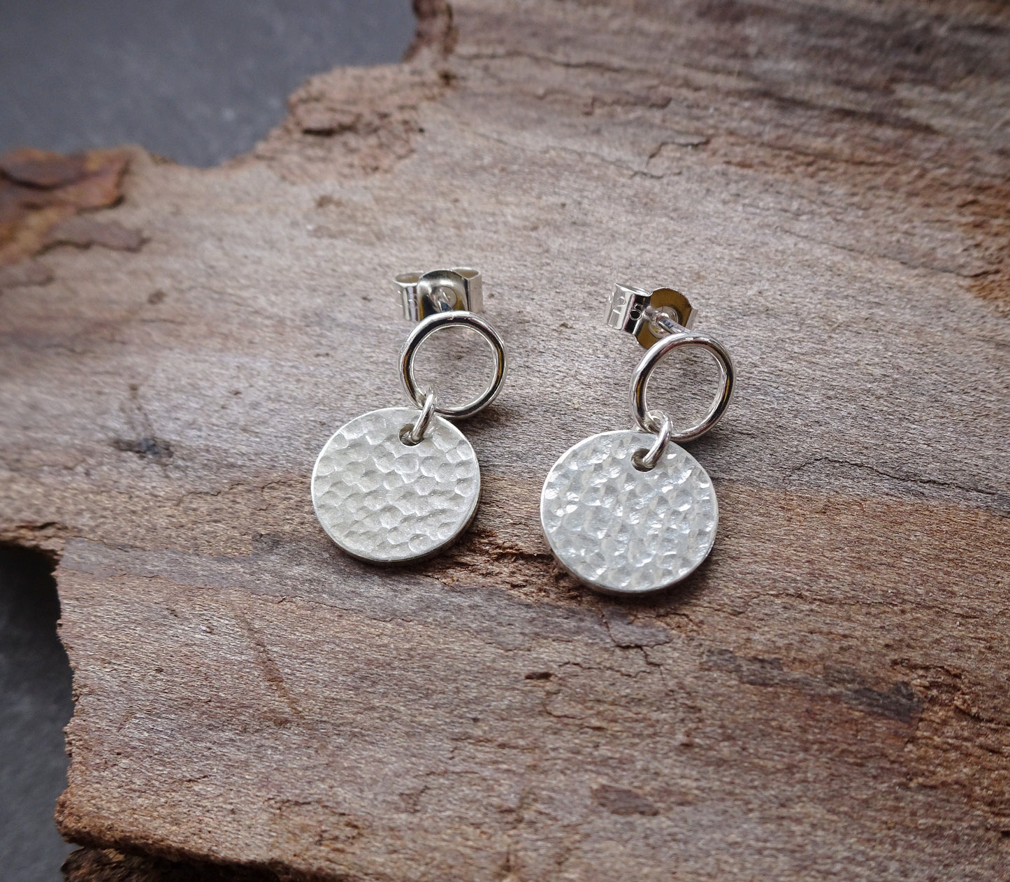 Sterling silver circle and hammered disc stud earrings.