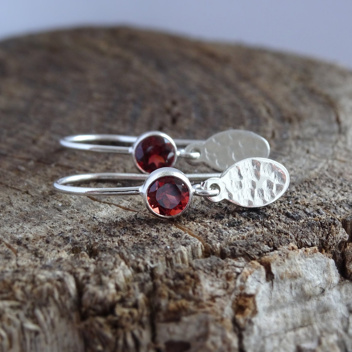 Garnet birthstone sterling silver dangle textured oval earrings.