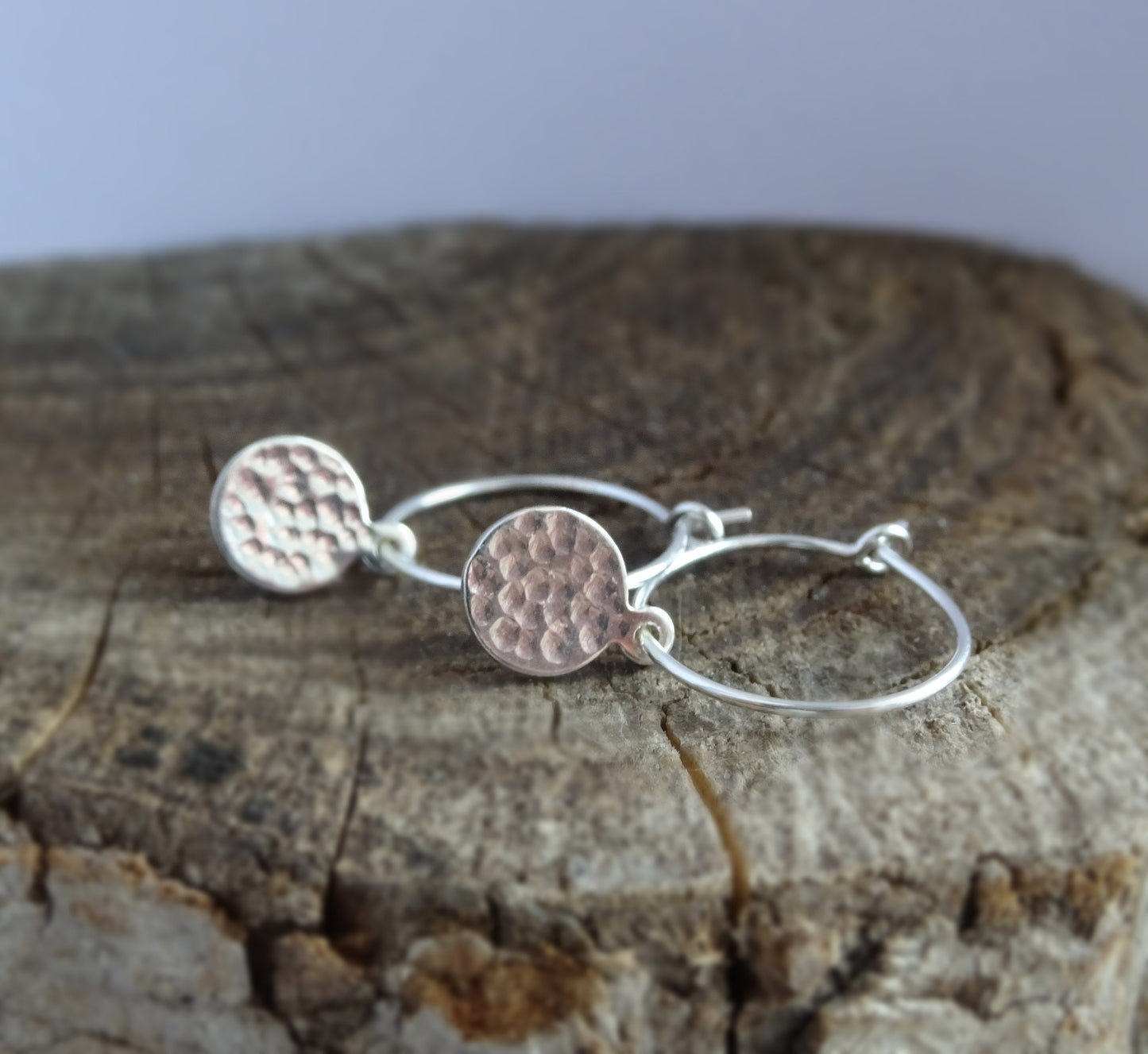 Small hammered sterling silver disc charm hoop earrings.