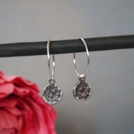 Hammered sterling silver disc charm hoop earrings.
