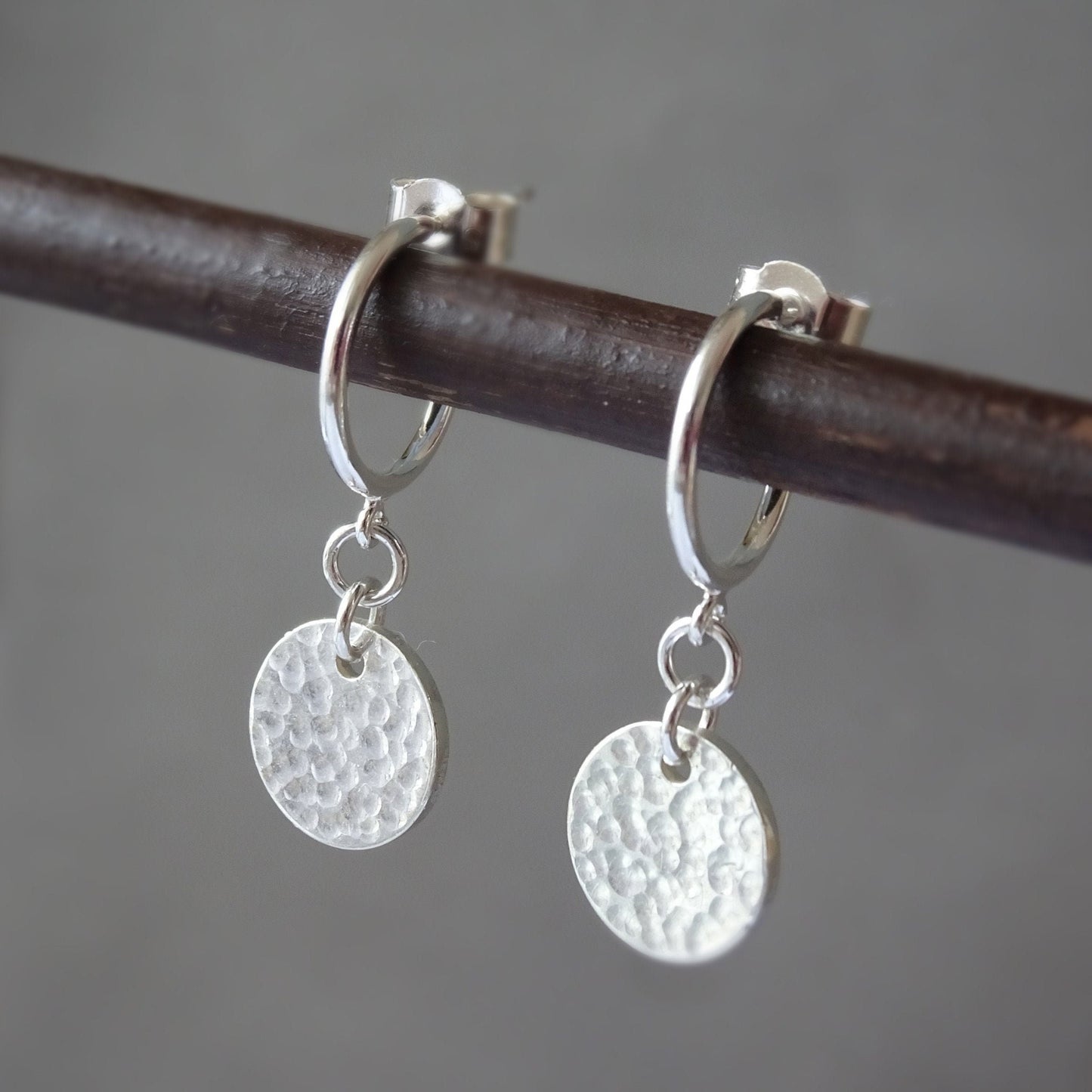 Sterling silver disc charm half hoop earrings.
