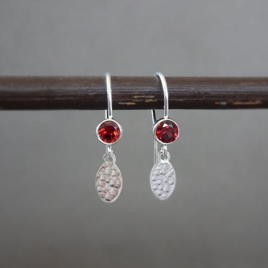 Garnet birthstone sterling silver dangle textured oval earrings.