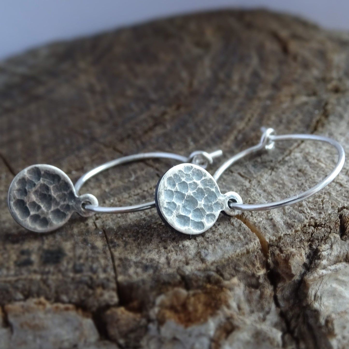 Hammered sterling silver disc charm hoop earrings.