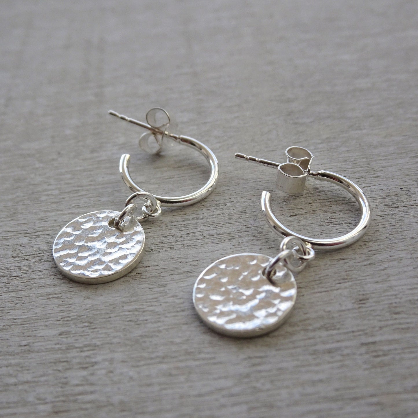 Sterling silver disc charm half hoop earrings.