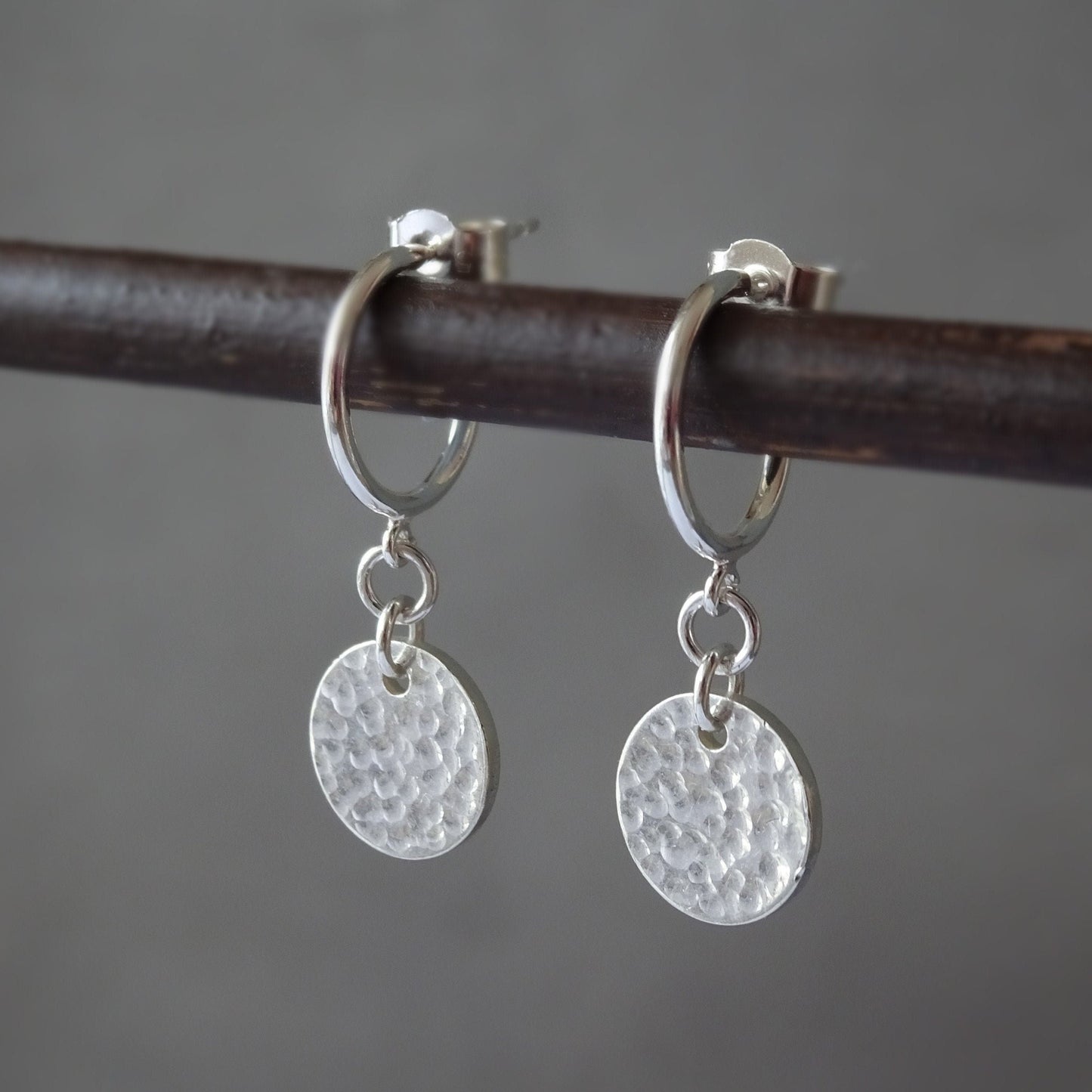 Sterling silver disc charm half hoop earrings.