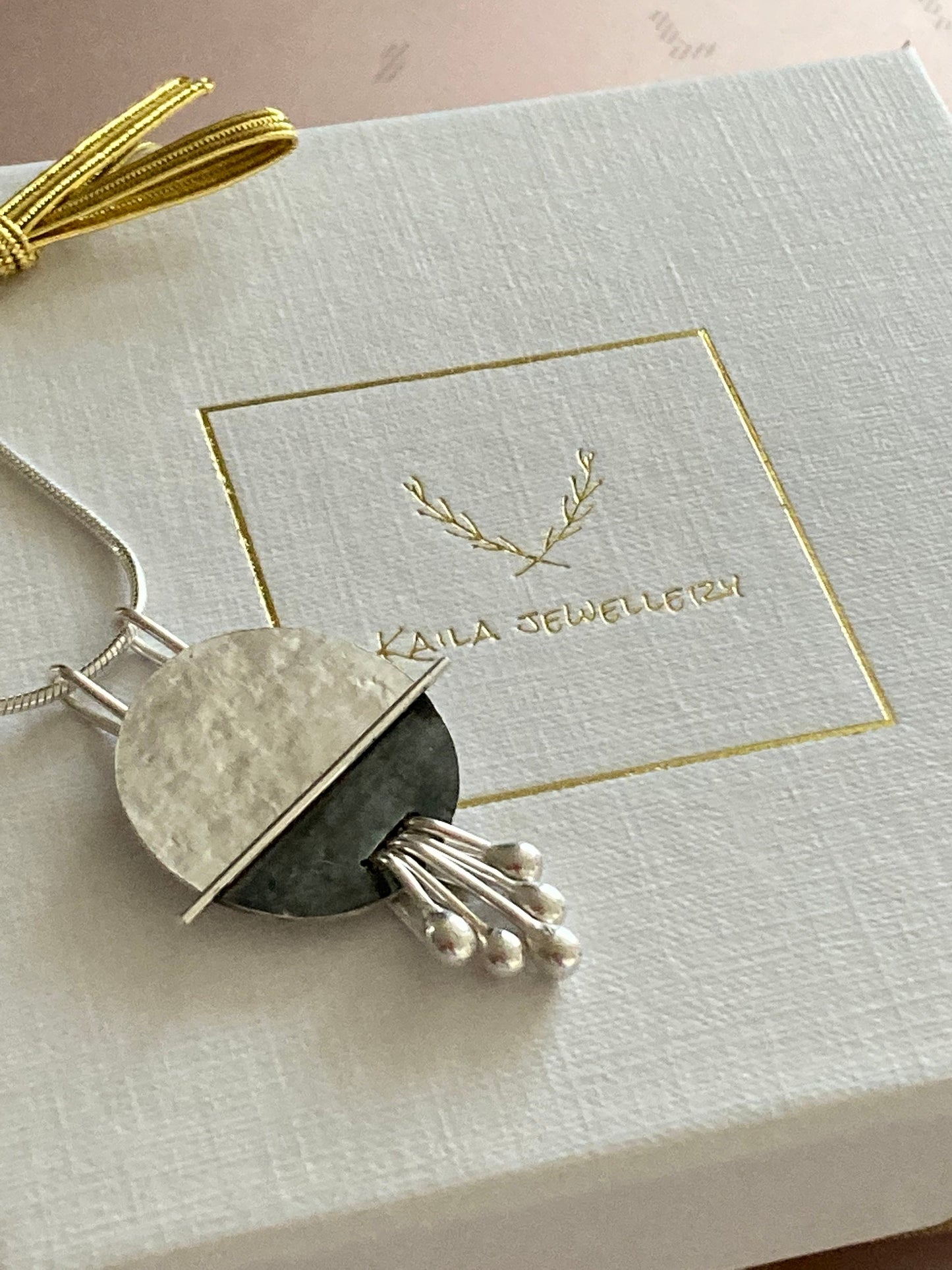 Sterling silver disc textured necklace pendant.
