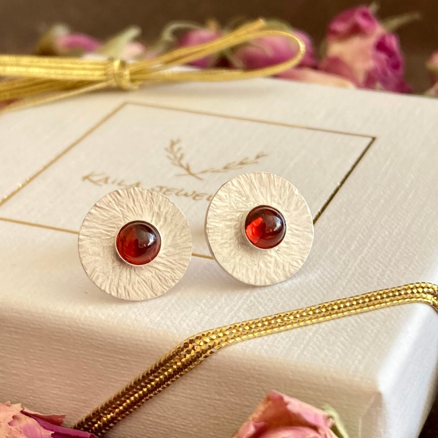 Garnet sterling silver hammered disc stud earrings.