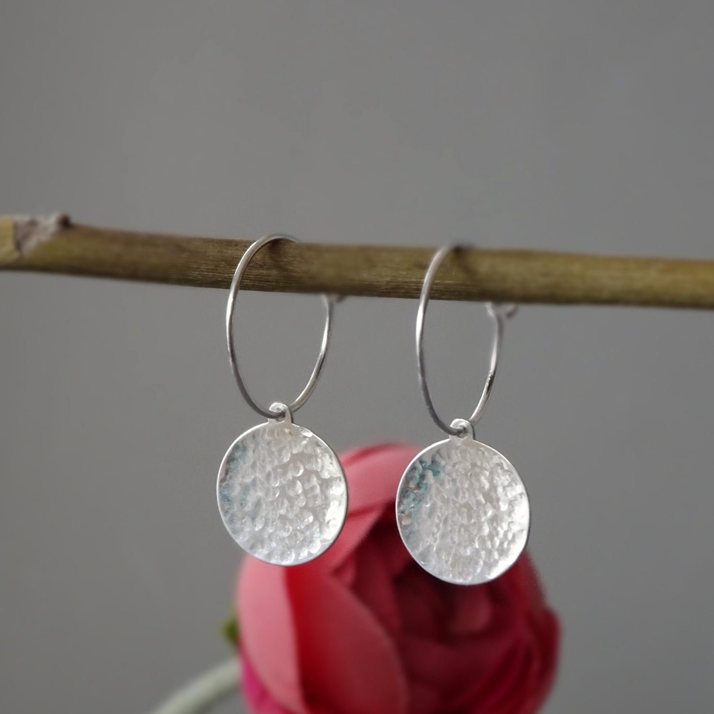 Hammered sterling silver disc hoop earrings.