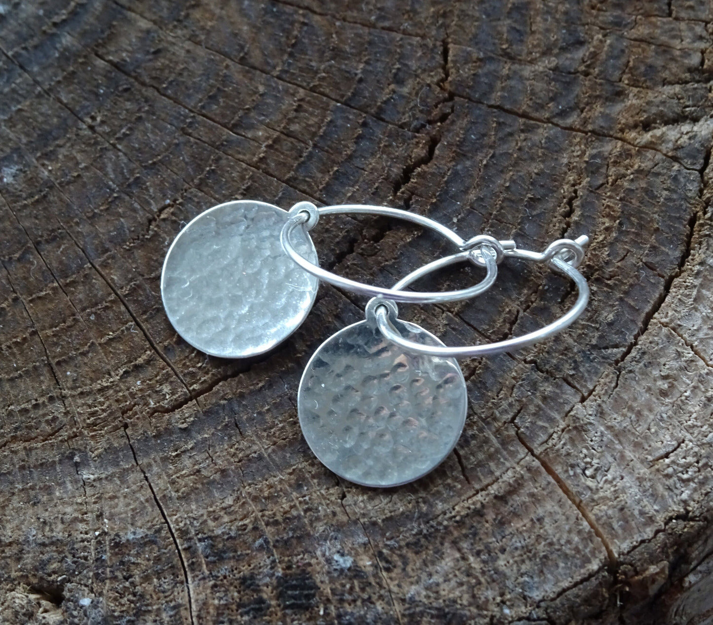 Hammered sterling silver disc hoop earrings.