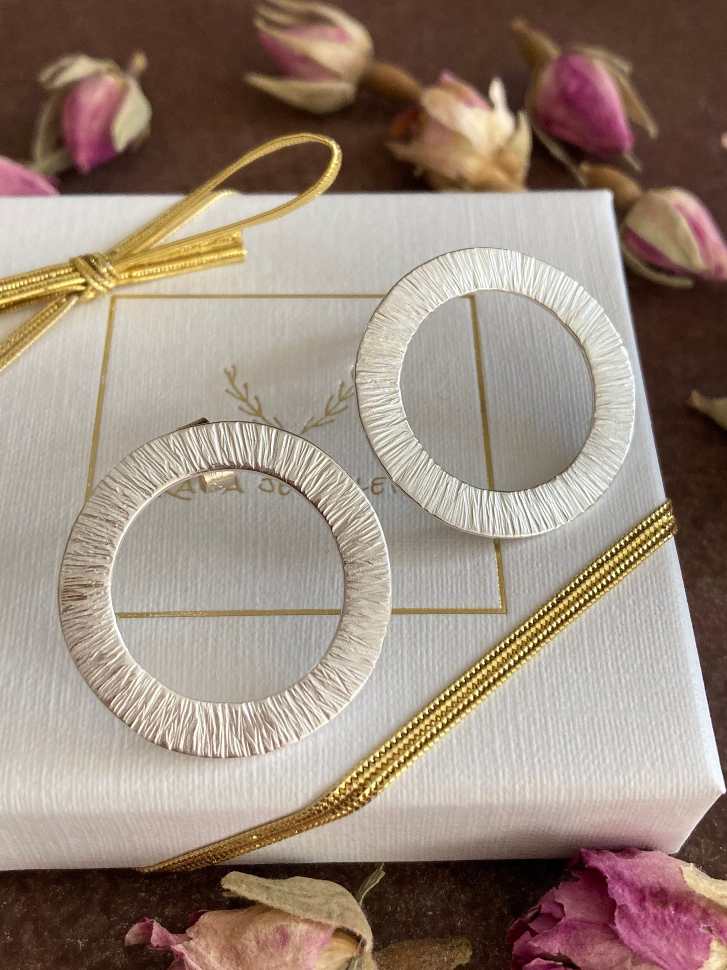 Large sterling silver circle stud earrings.
