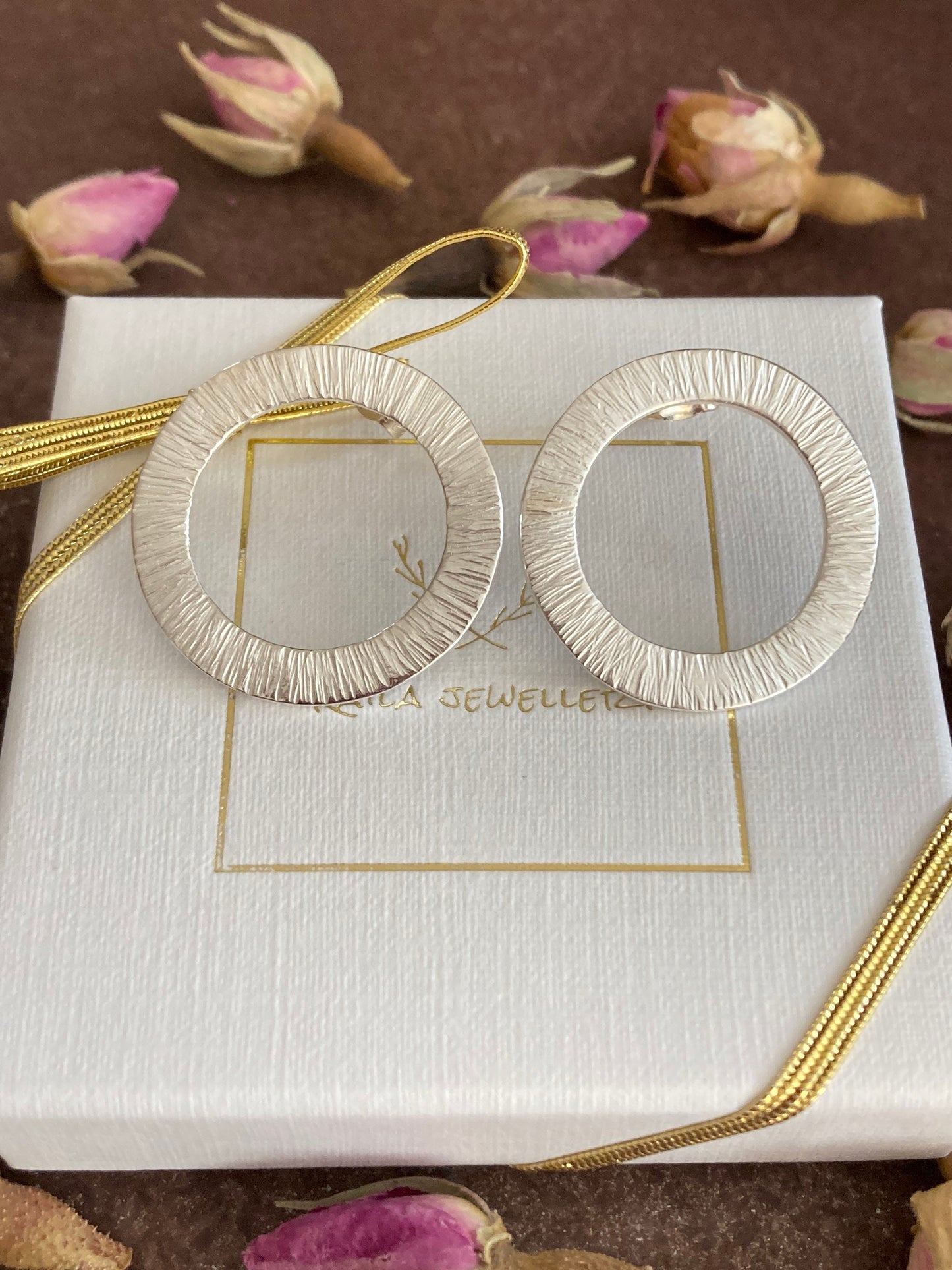 Large sterling silver circle stud earrings.