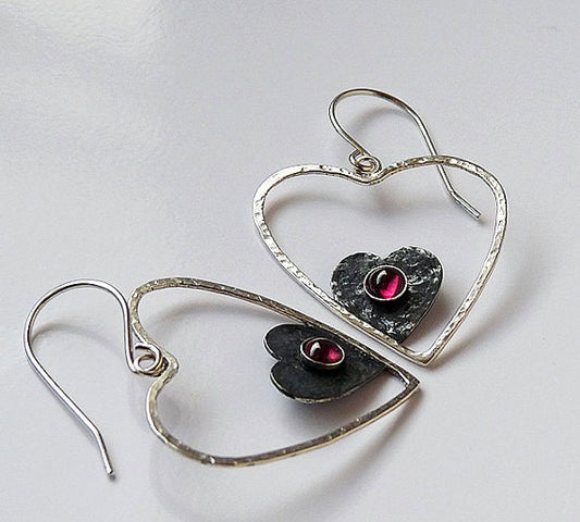 Sterling silver garnet heart earrings.