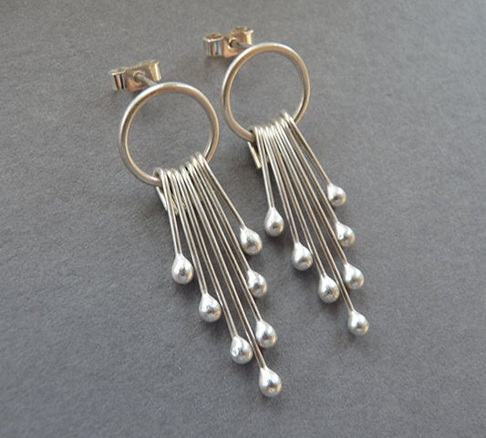Sterling silver circle and droplets stud earrings.